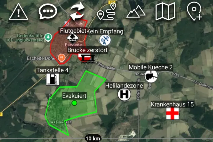 ATAK-Karte mit rot eingezeichnetem Flutgebiet, grün markiertem Evakuierungsbereich, Hubschrauberlandeplatz und Krankenhaus.